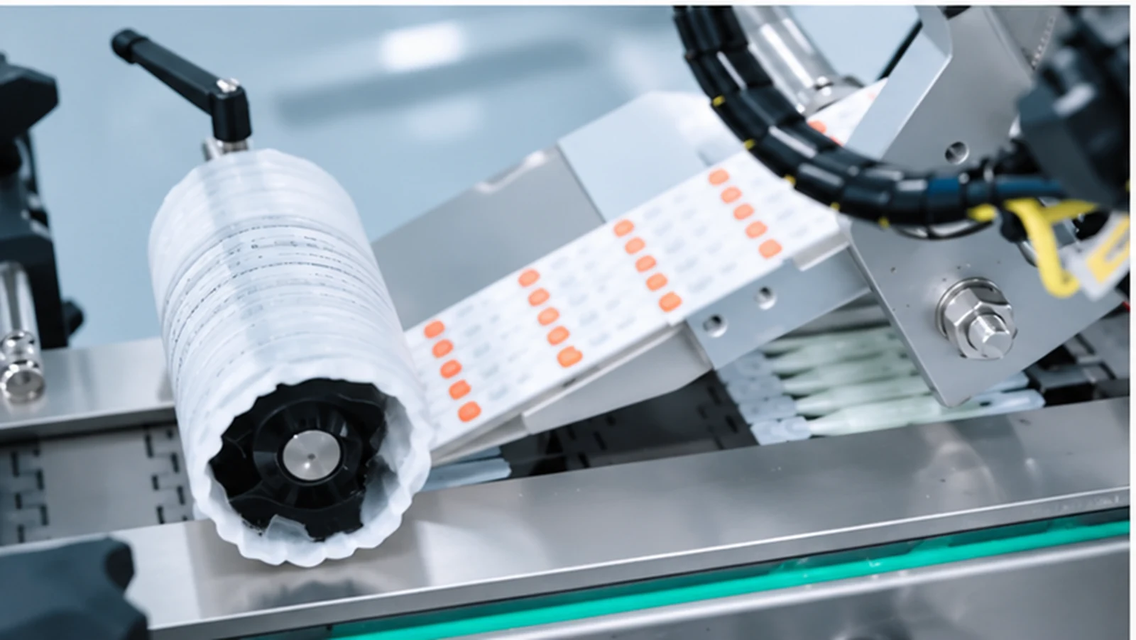 Close view of a reel, printed web and guides inside an automated machine